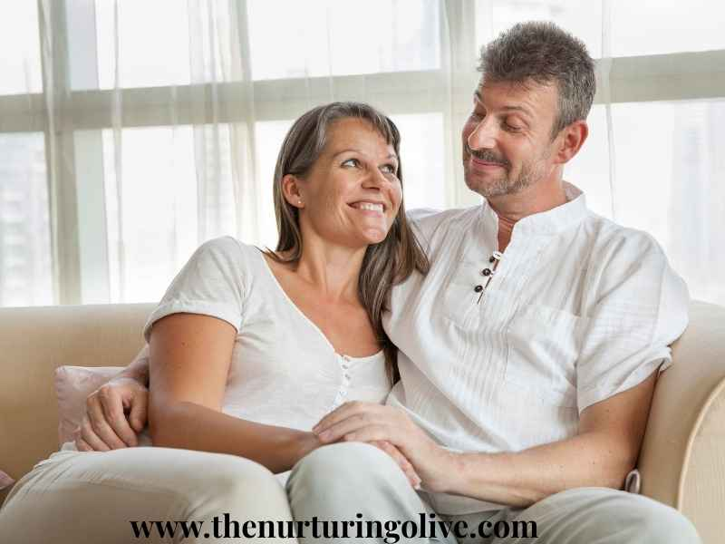 happy-married-couple-holding-hands-laughing-together-how-to-keep-the-fire-of-love-burning-after-many-years
