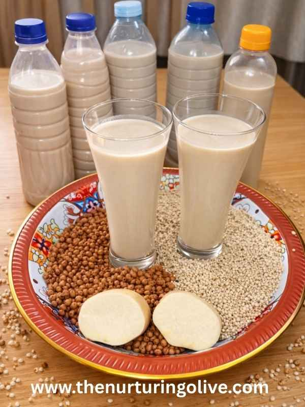 glasses-of-homemade-kunu-drink-sitting-on-millets-sorghum-and-tigenut-grains-ready-to-enjoy-and-some-bottles-containing-kunu-drink-all-sitting-on-a-dinner-table