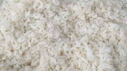 How to cook white rice shown as freshly cooked white rice still in the pot after cooking