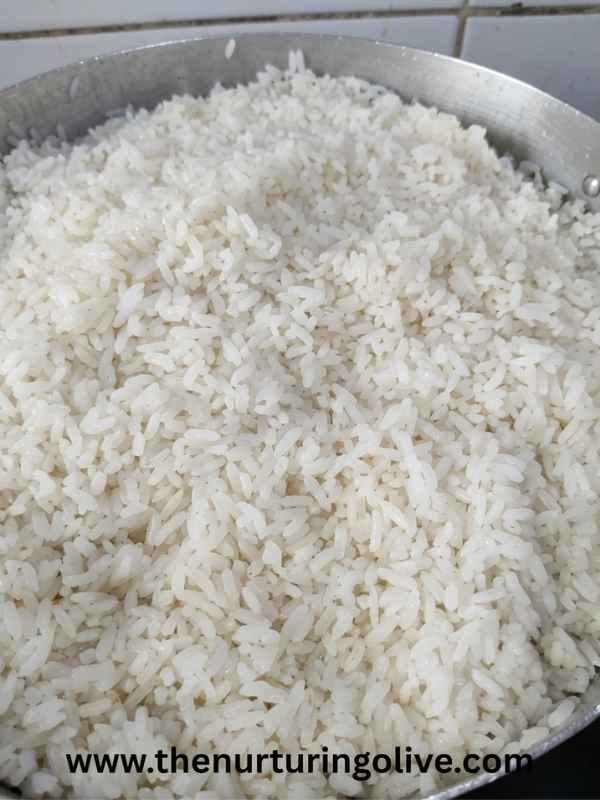 How to cook white rice shown as freshly cooked white rice still in the pot after cooking