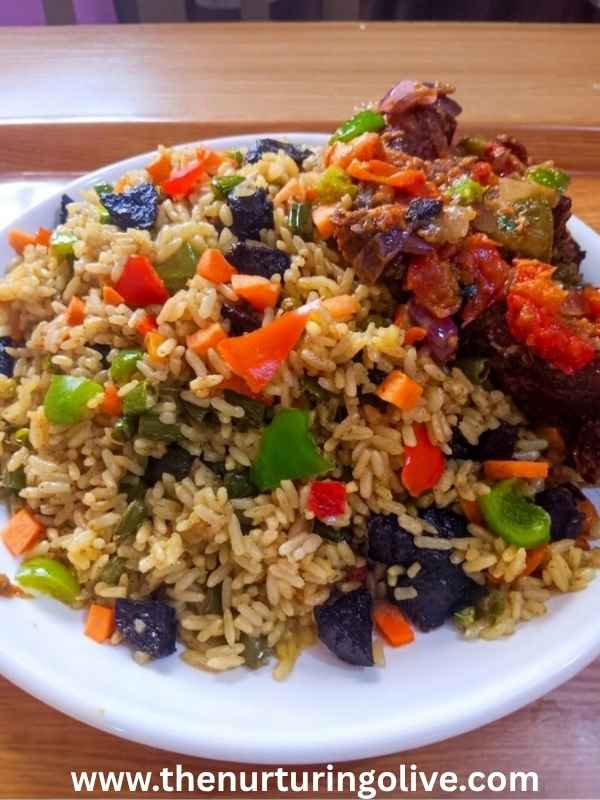 Fresh Nigerian fried rice served on the dining table showing the final result of how to make Nigerian fried rice at home