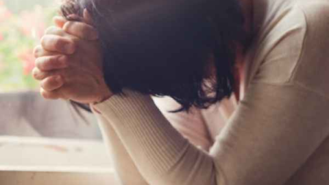 Woman praying and seeking God while learning how to heal after a breakup as a Christian