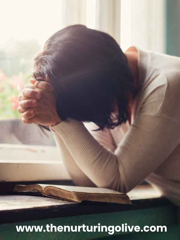 Woman praying and seeking God while learning how to heal after a breakup as a Christian